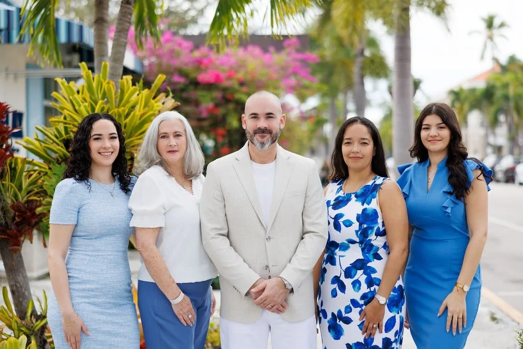 The Alpizar & Company real estate team in Naples, Florida — Robert and Marlene Alpizar with the firm's advisors